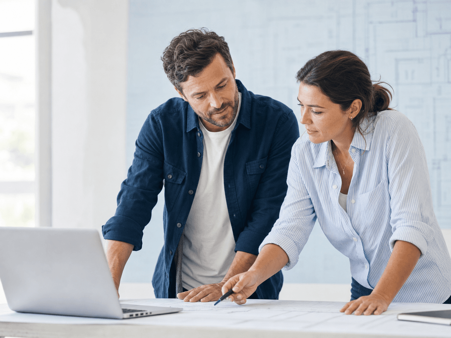 Construction company leaders reviewing plans together